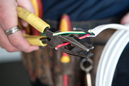 MSA Electrical professional using wire strippers on electrical cables
